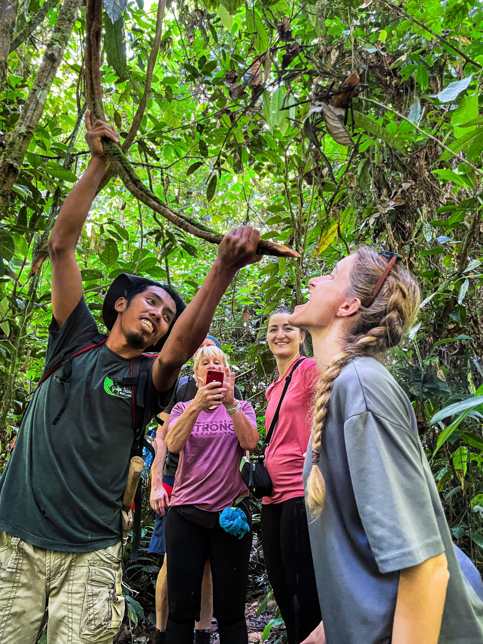 Local guide sharing rainforest knowledge during a Bukit Lawang trek