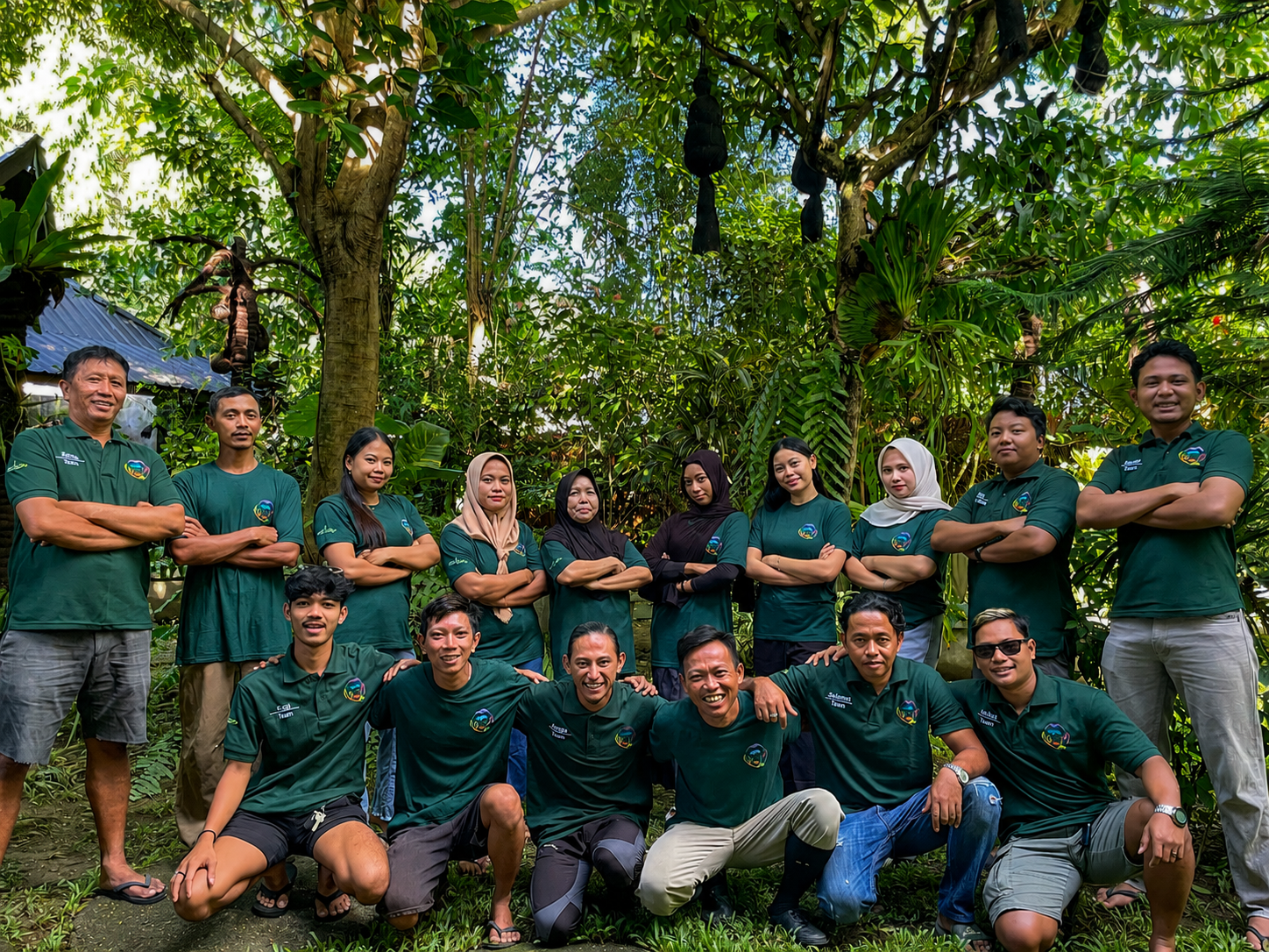 The local Bukit Lawang Travel team standing together beneath rainforest trees